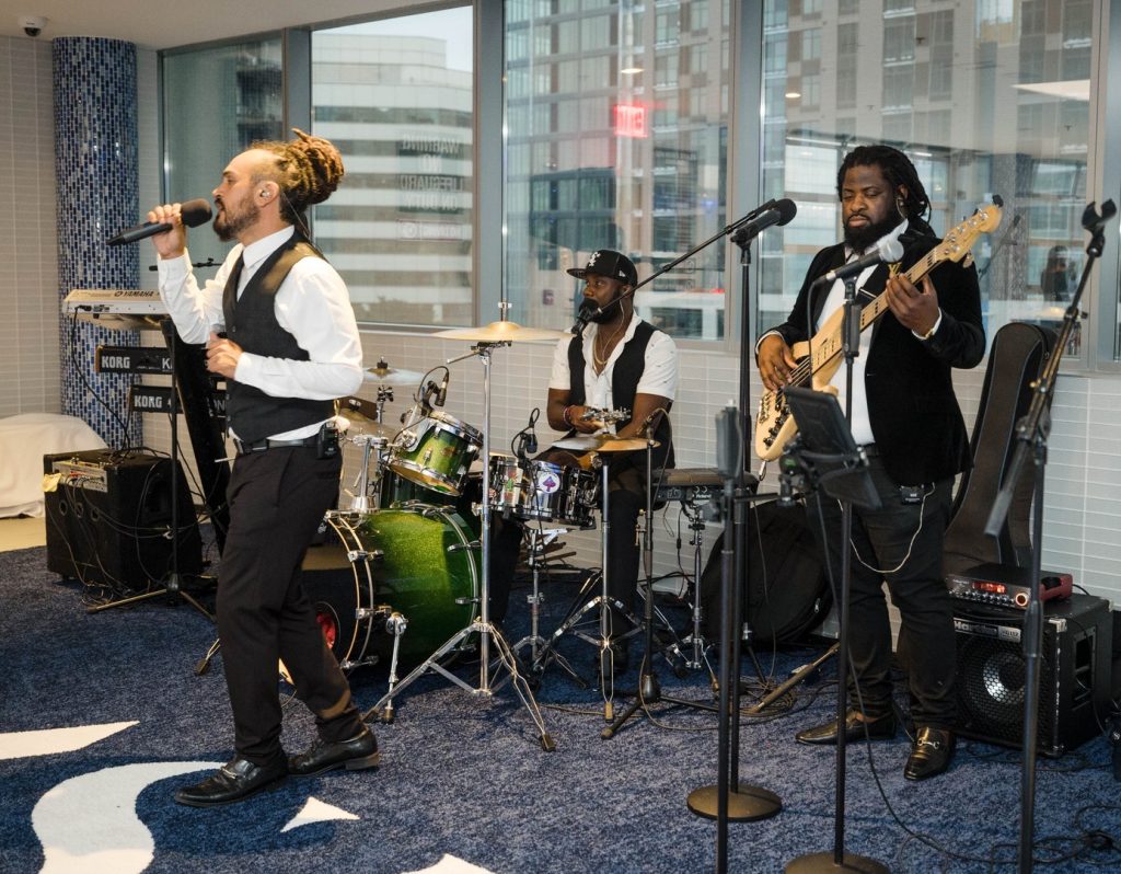 Live band performing indoors during Atlantic Station West Grand Opening in Stamford